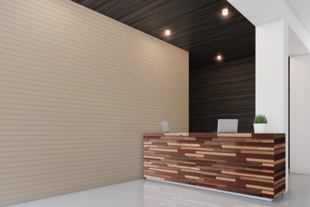 Side view of a reception desk standing in an office with dark wooden wall elements. 3d rendering, mock up
